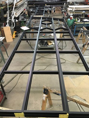 A metal frame is being built in a workshop.