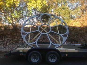 A large ferris wheel is sitting on top of a trailer.