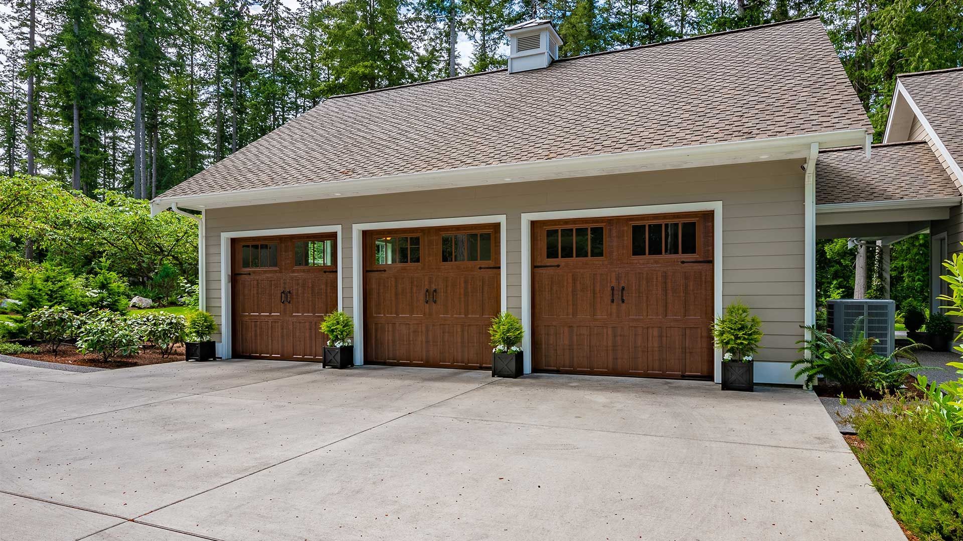 A house with three garage doors and a driveway