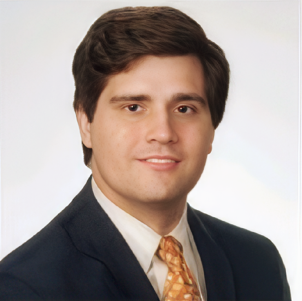 A man in a suit and tie smiles for the camera