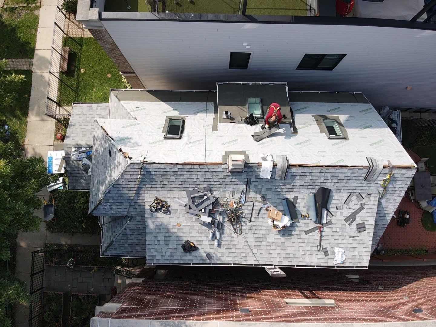 An aerial view of a house with a roof under construction.