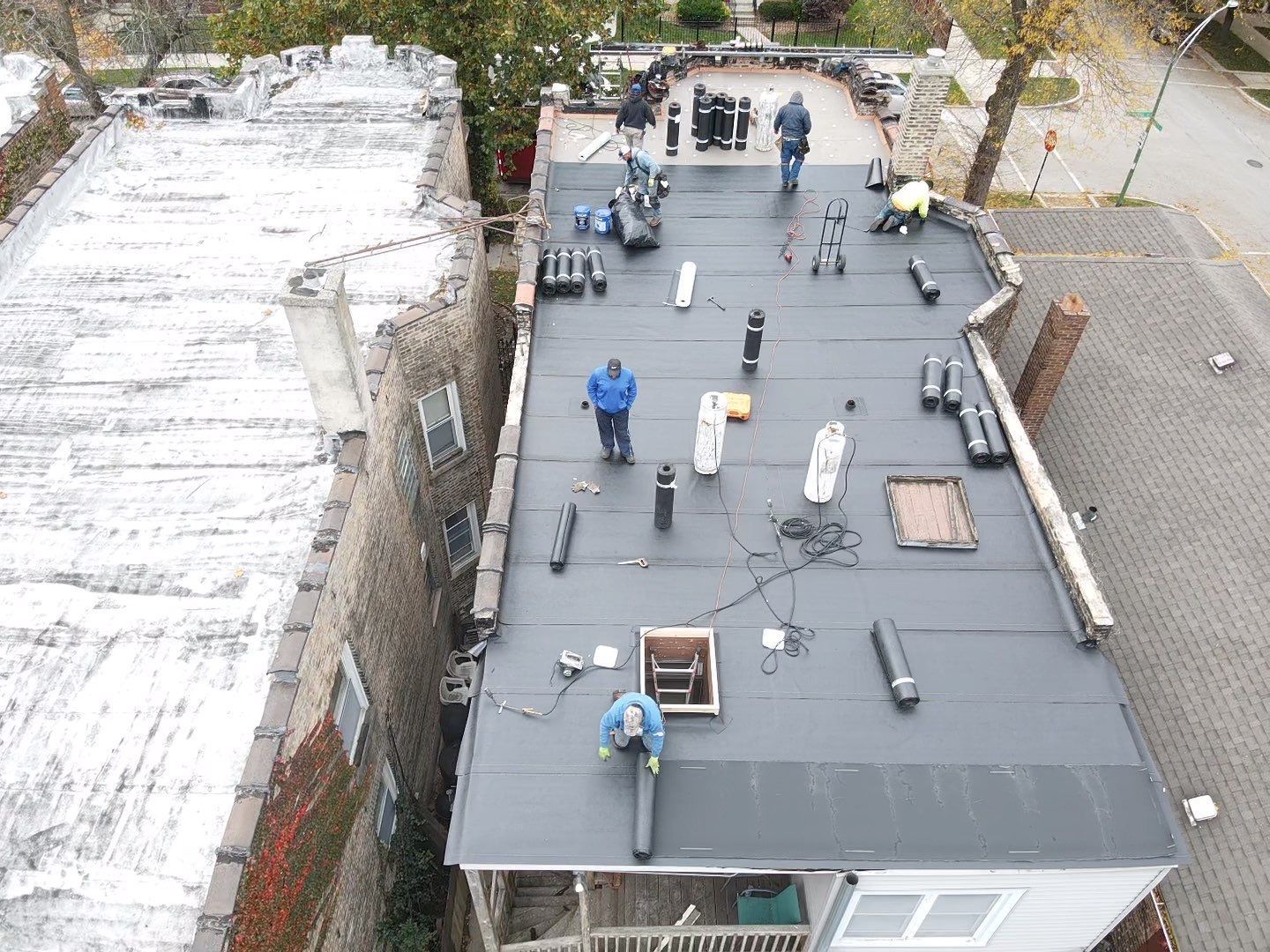 A group of people are working on the roof of a building.