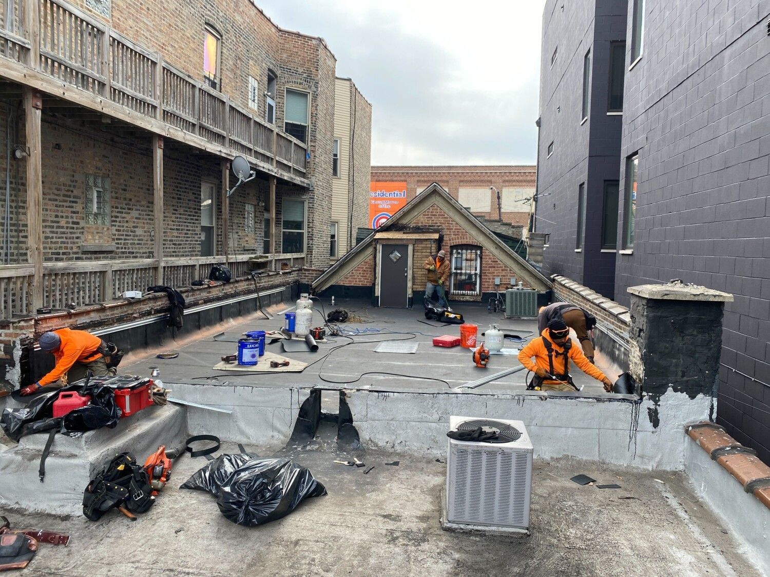 A group of men are working on the roof of a building.
