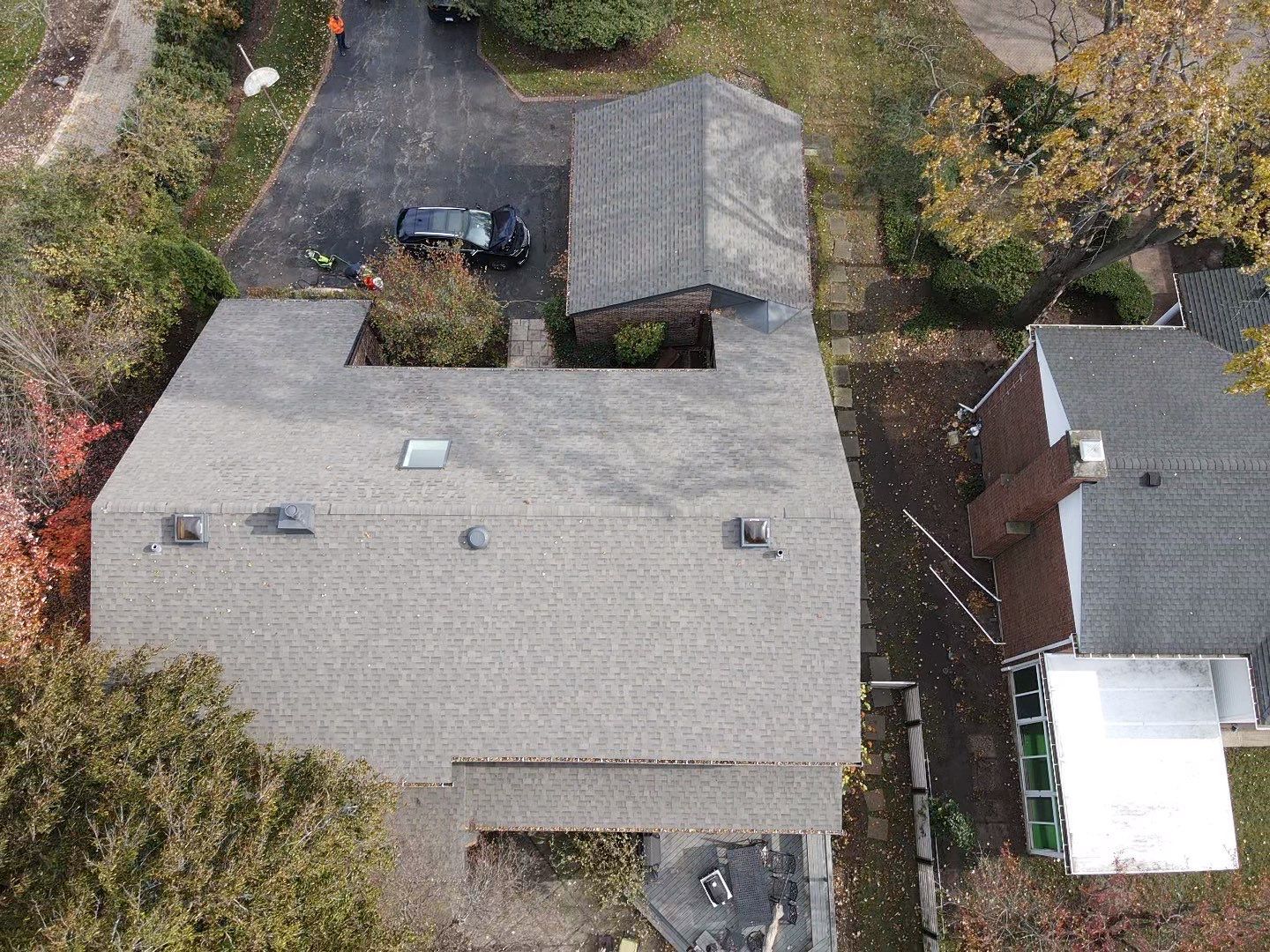 An aerial view of a house with a car parked in front of it.