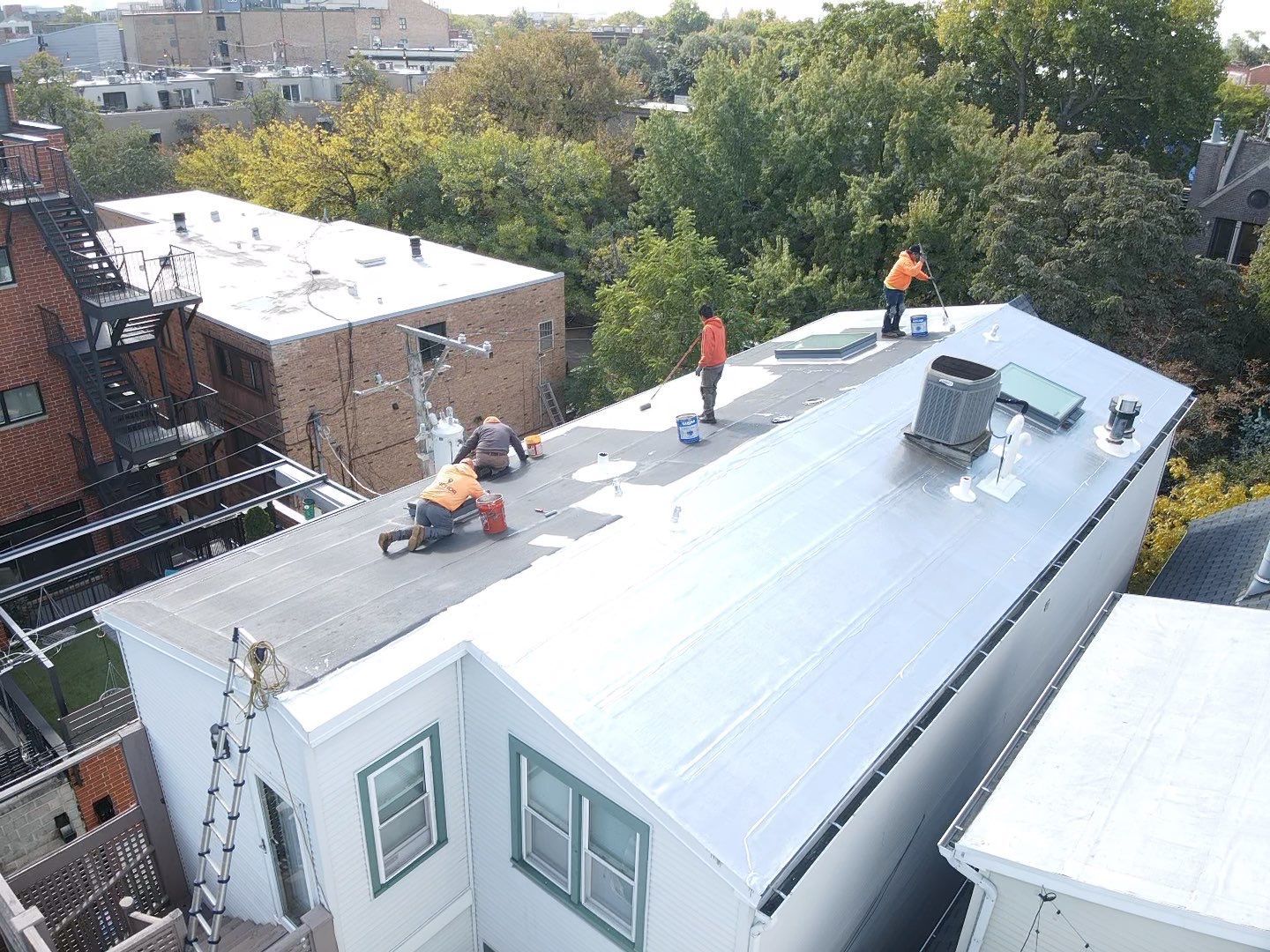 A group of people are working on the roof of a building.