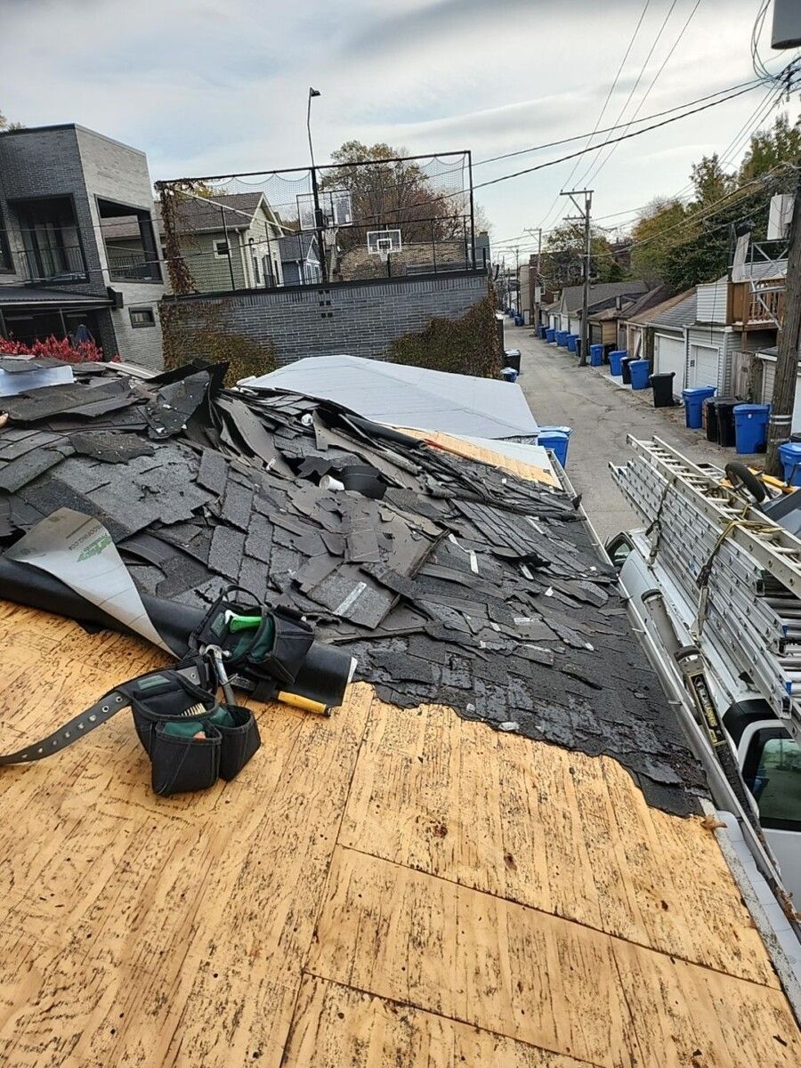 A roof with a lot of shingles on it is being repaired.