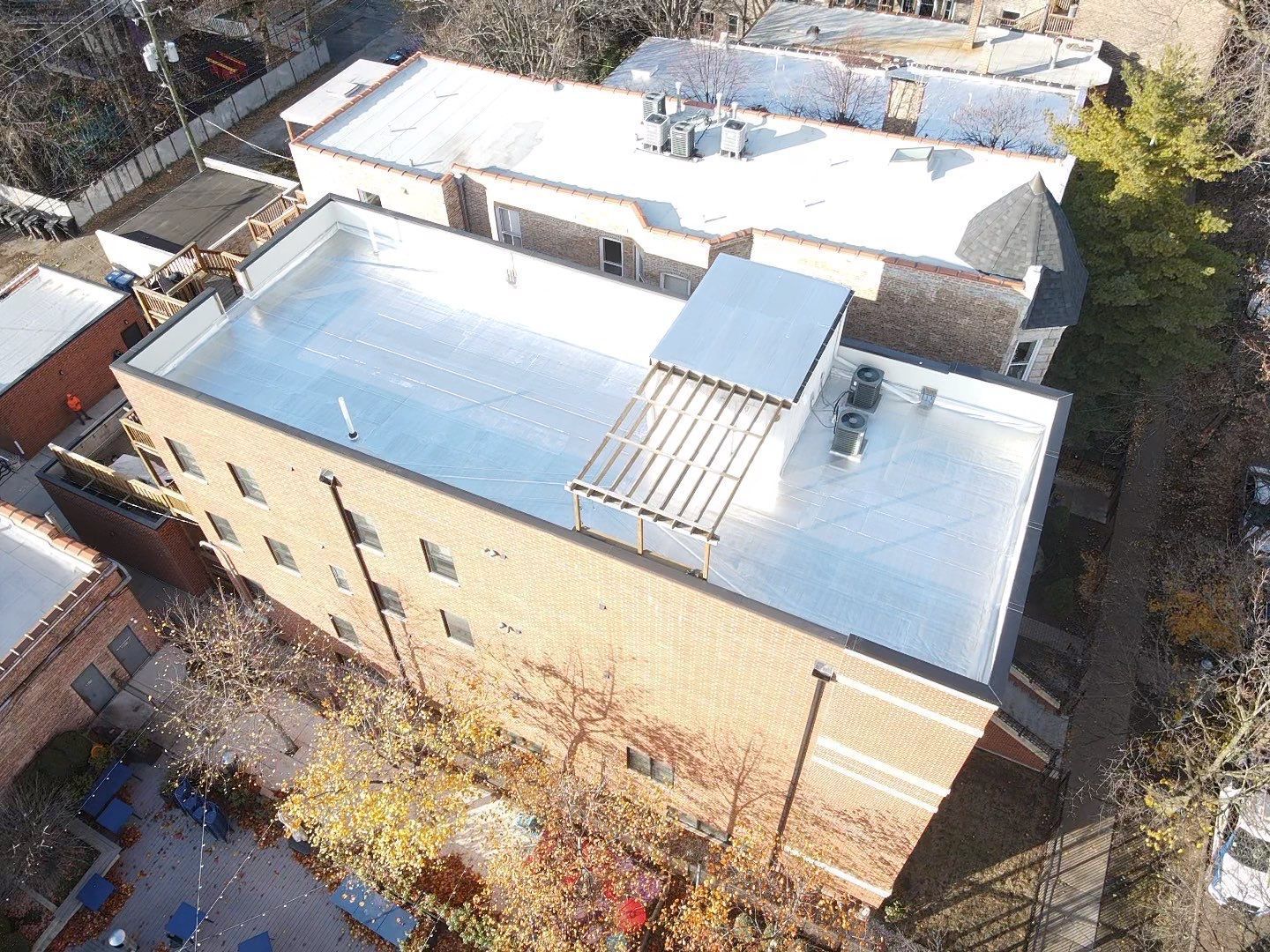 An aerial view of a building with a white roof