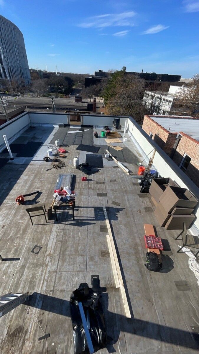 An aerial view of a roof with a crane on it.