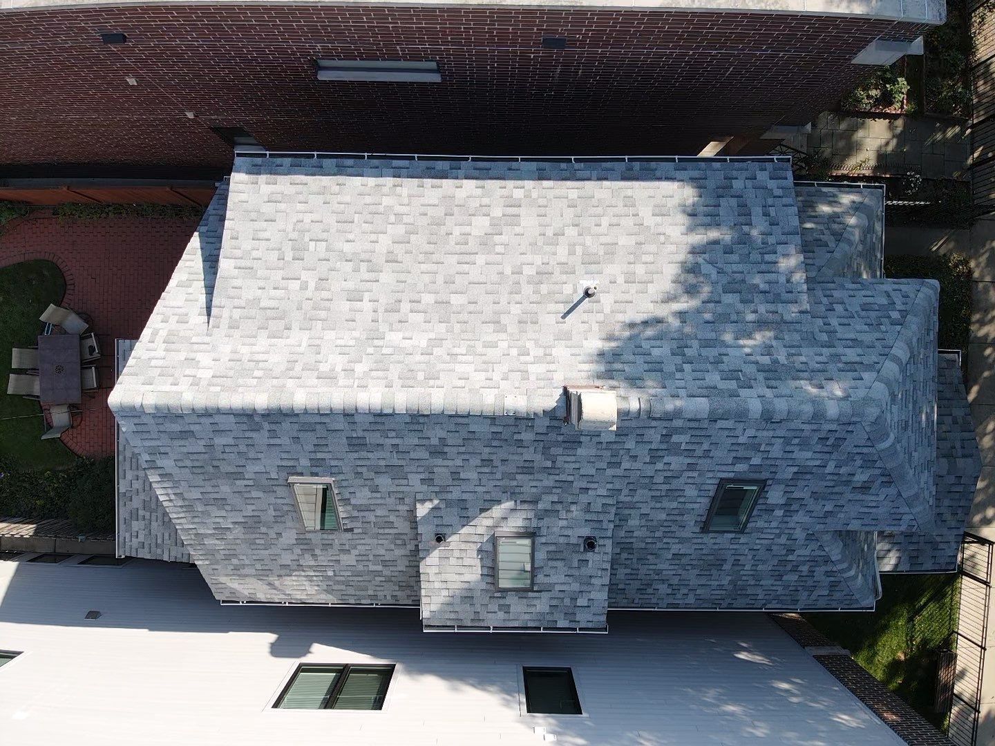 An aerial view of a house with a gray roof.