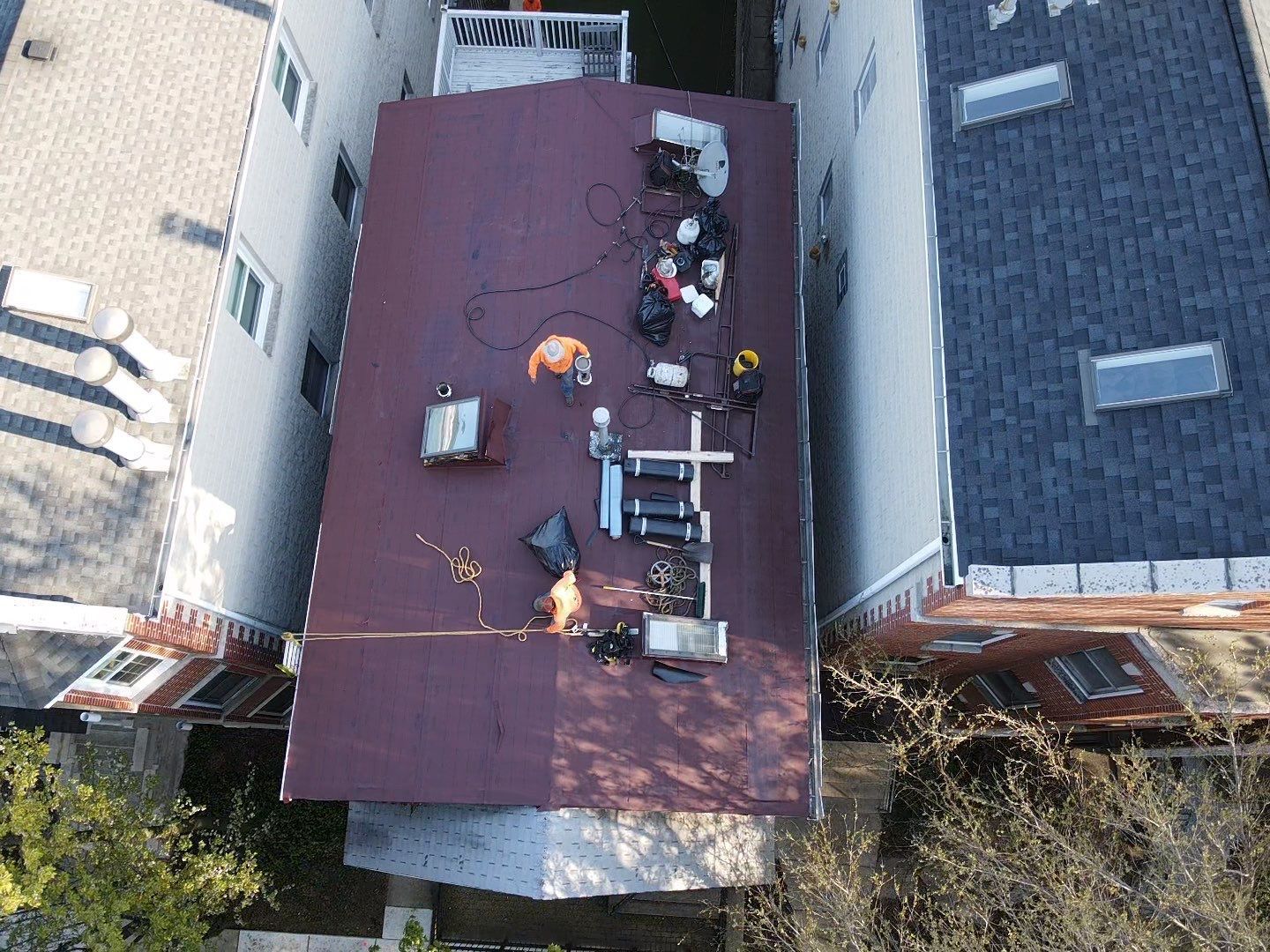 An aerial view of a roof with workers on it.