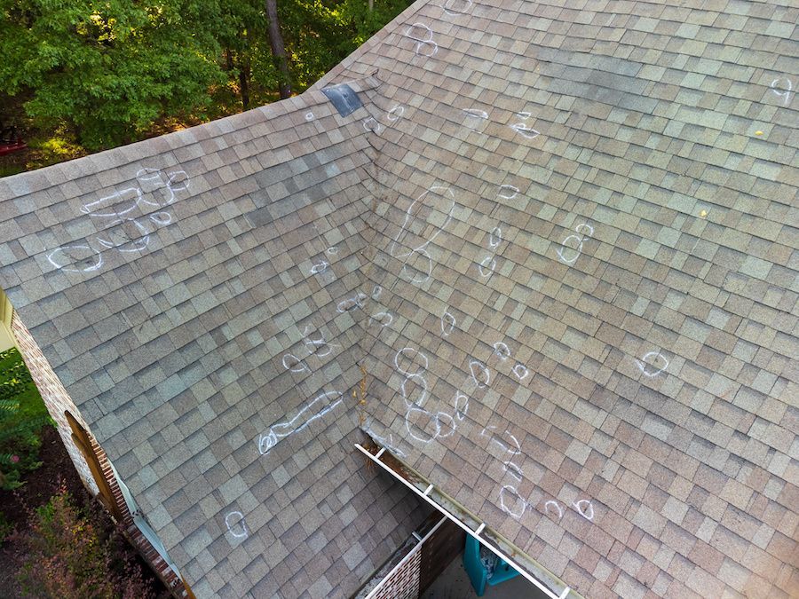 An aerial view of a roof with hail damage.