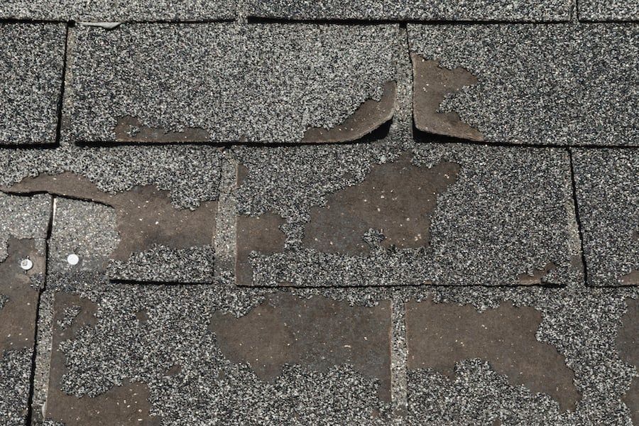 A close up of a roof with a lot of shingles missing
