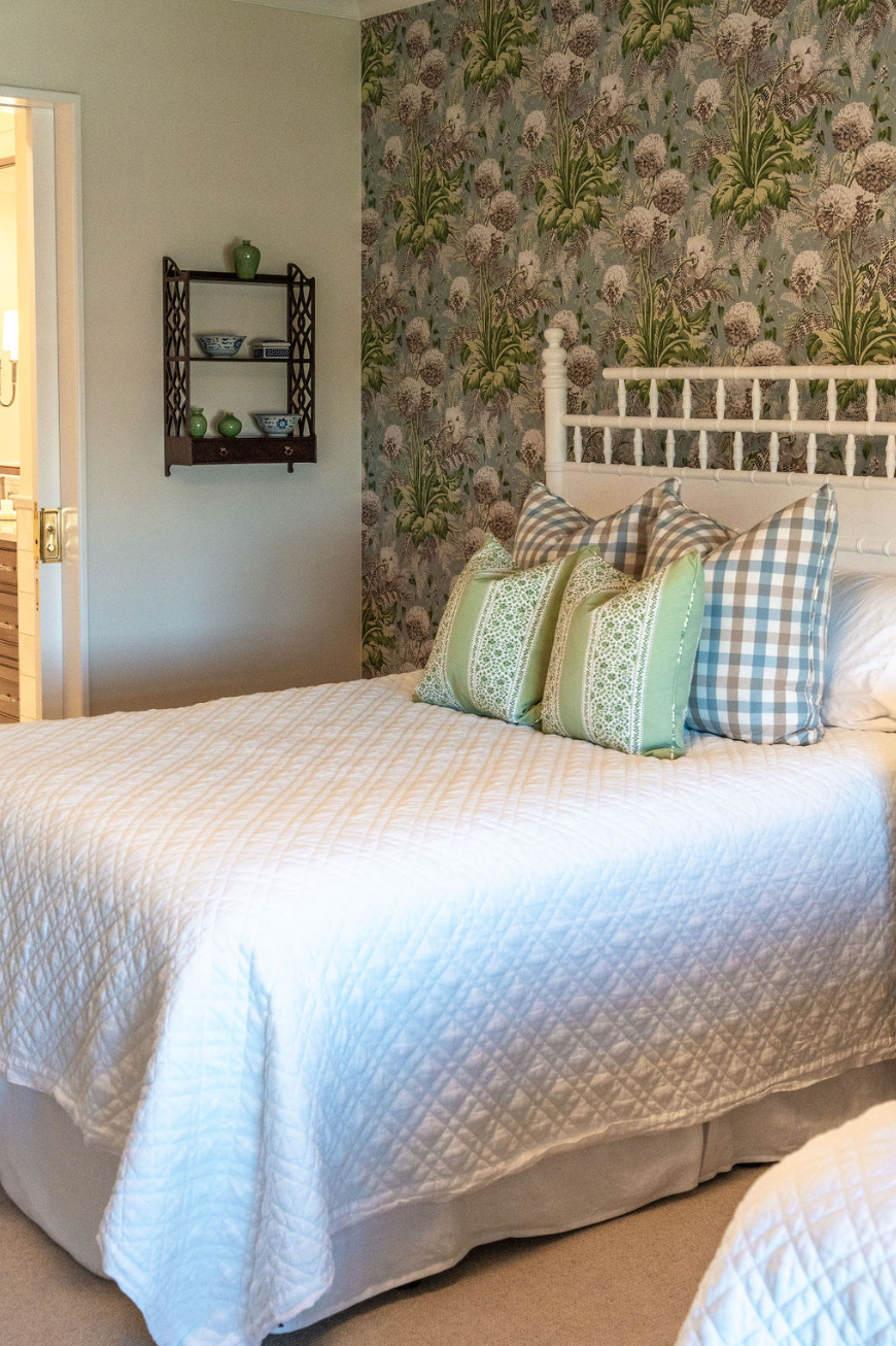 A bedroom with a large bed and pillows on it