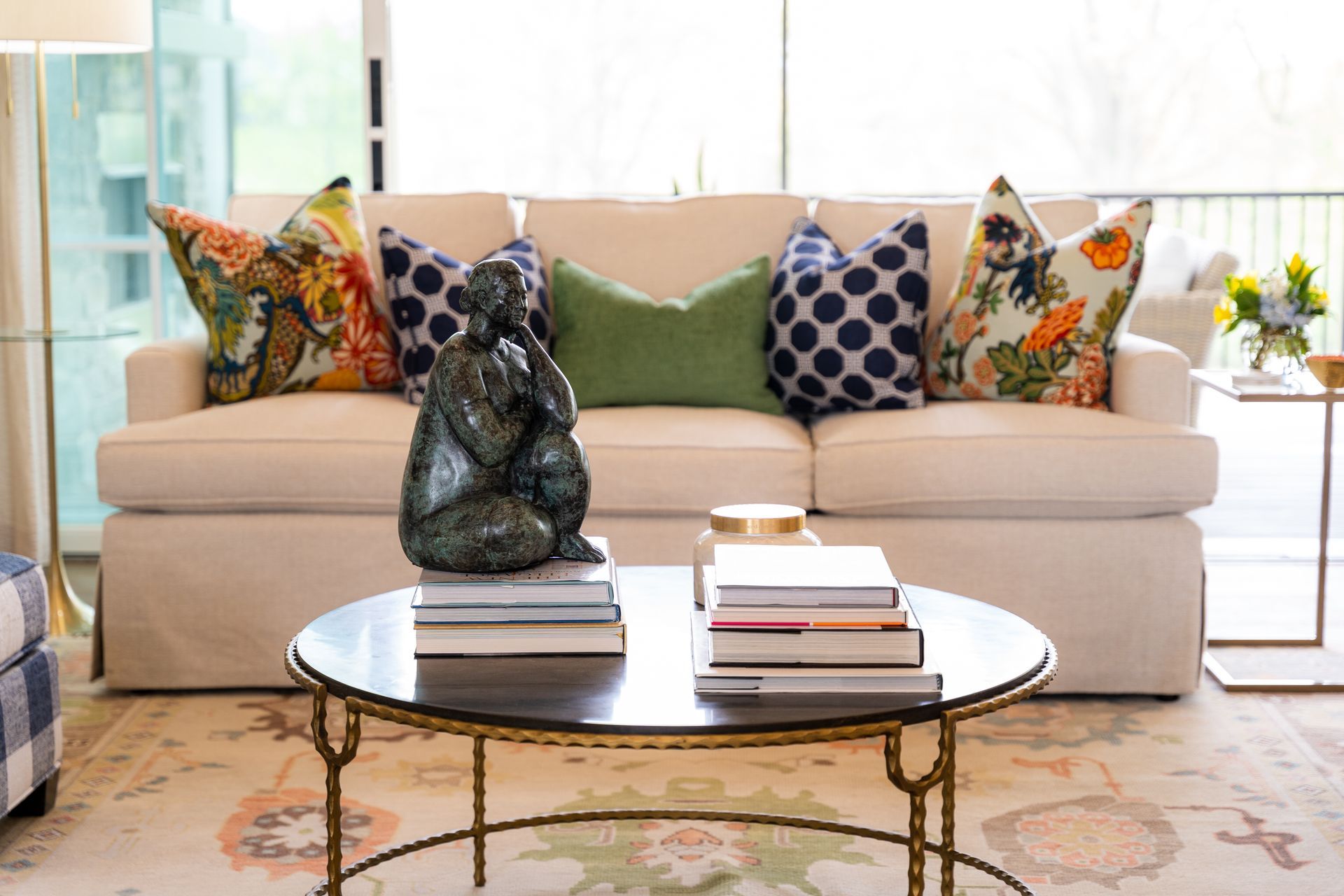 A living room with a couch , coffee table , and books.