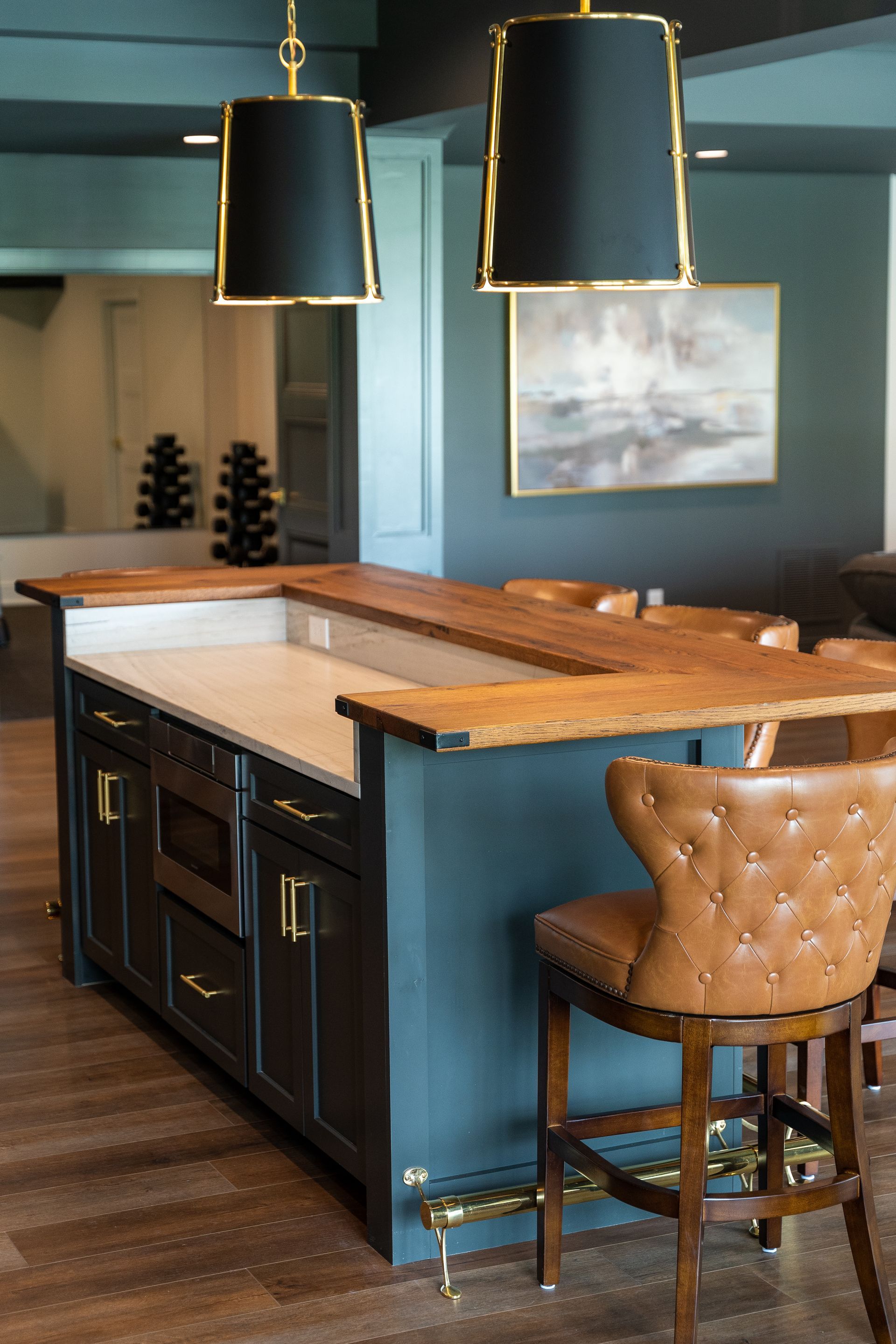 A kitchen with a large island and stools