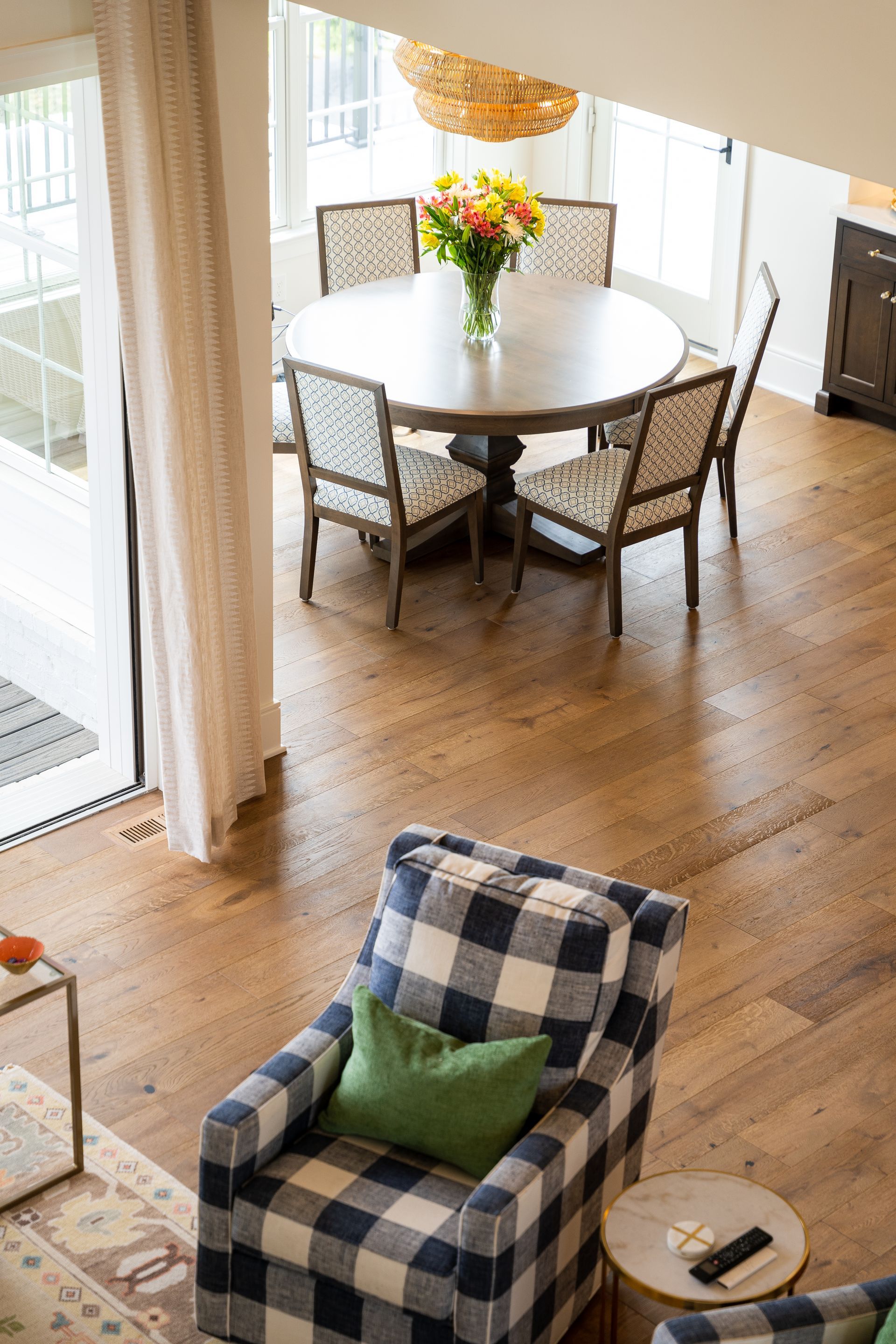 An aerial view of a living room with a dining table and chairs.