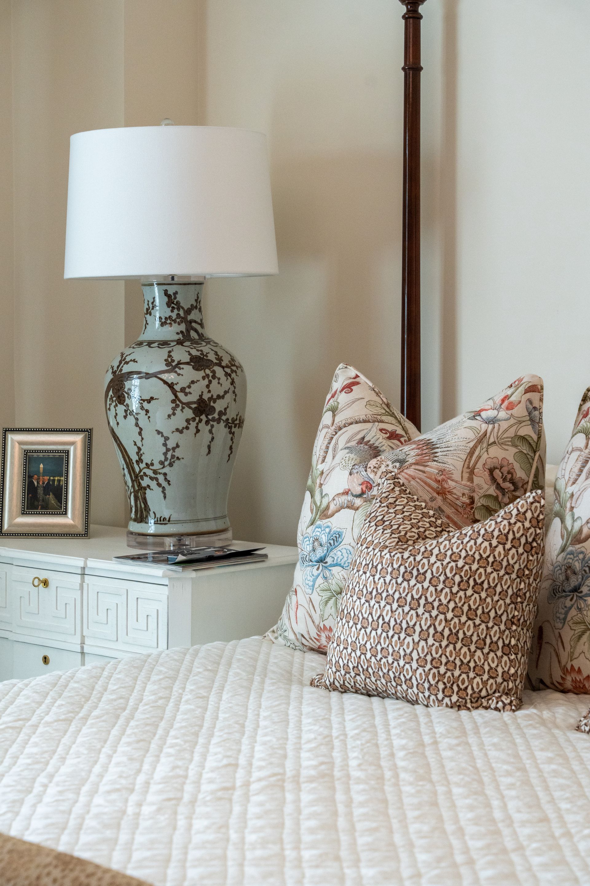 There is a lamp on the nightstand next to the bed.