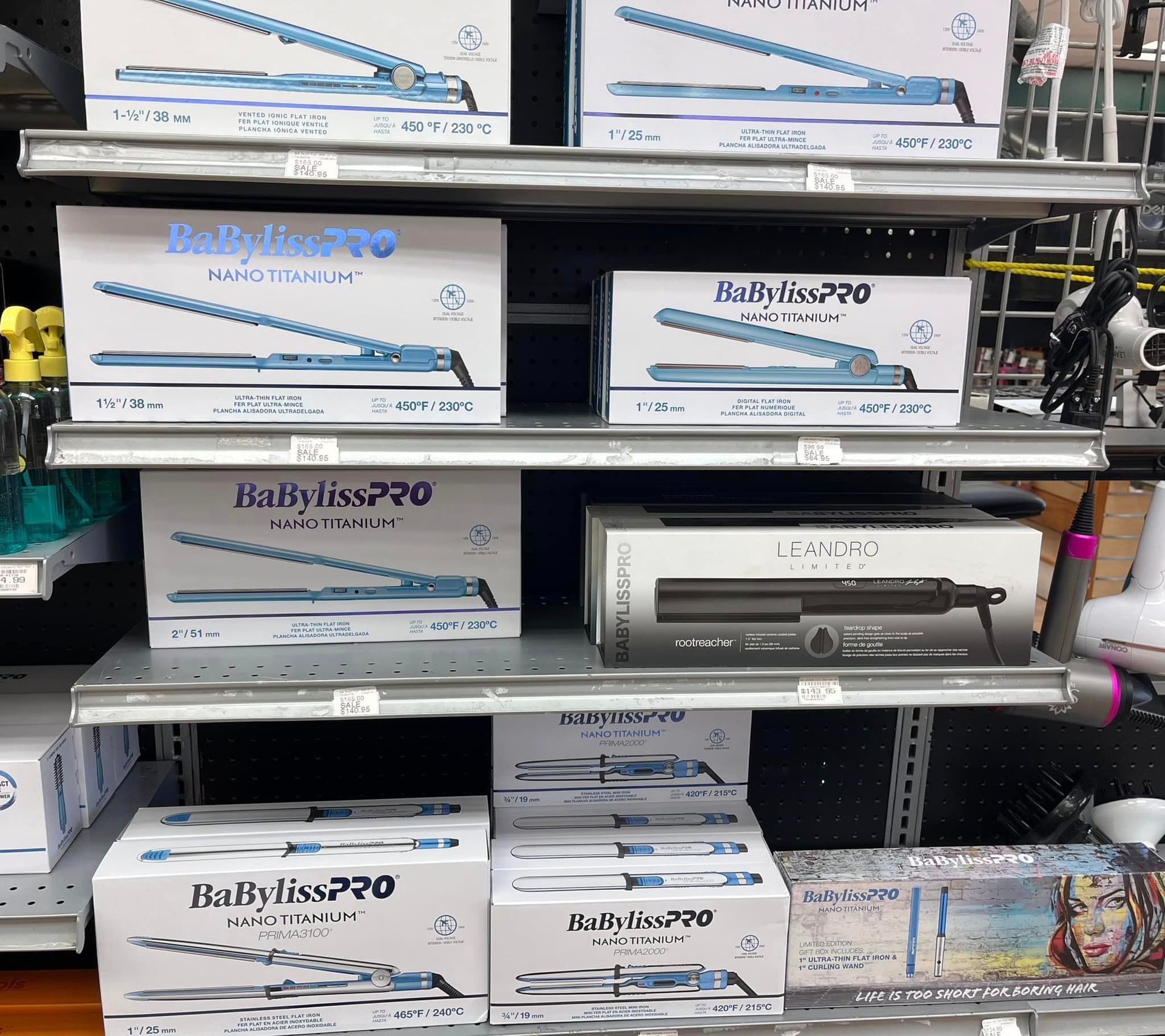 boxes of babyliss pro hair straighteners are on shelves in a store