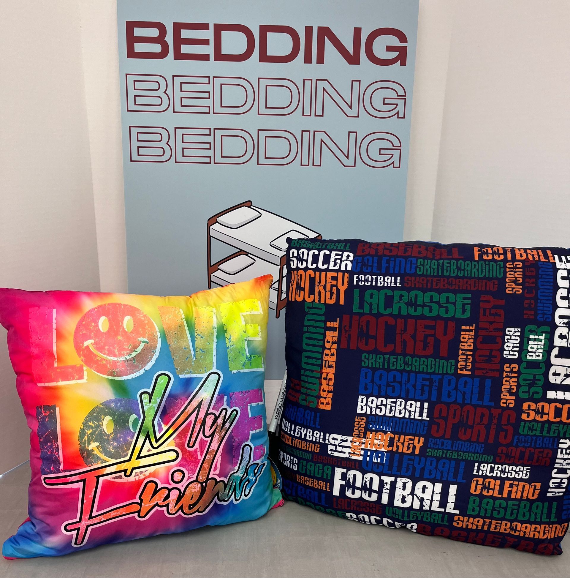 two colorful pillows are sitting next to a sign that says bedding bedding bedding