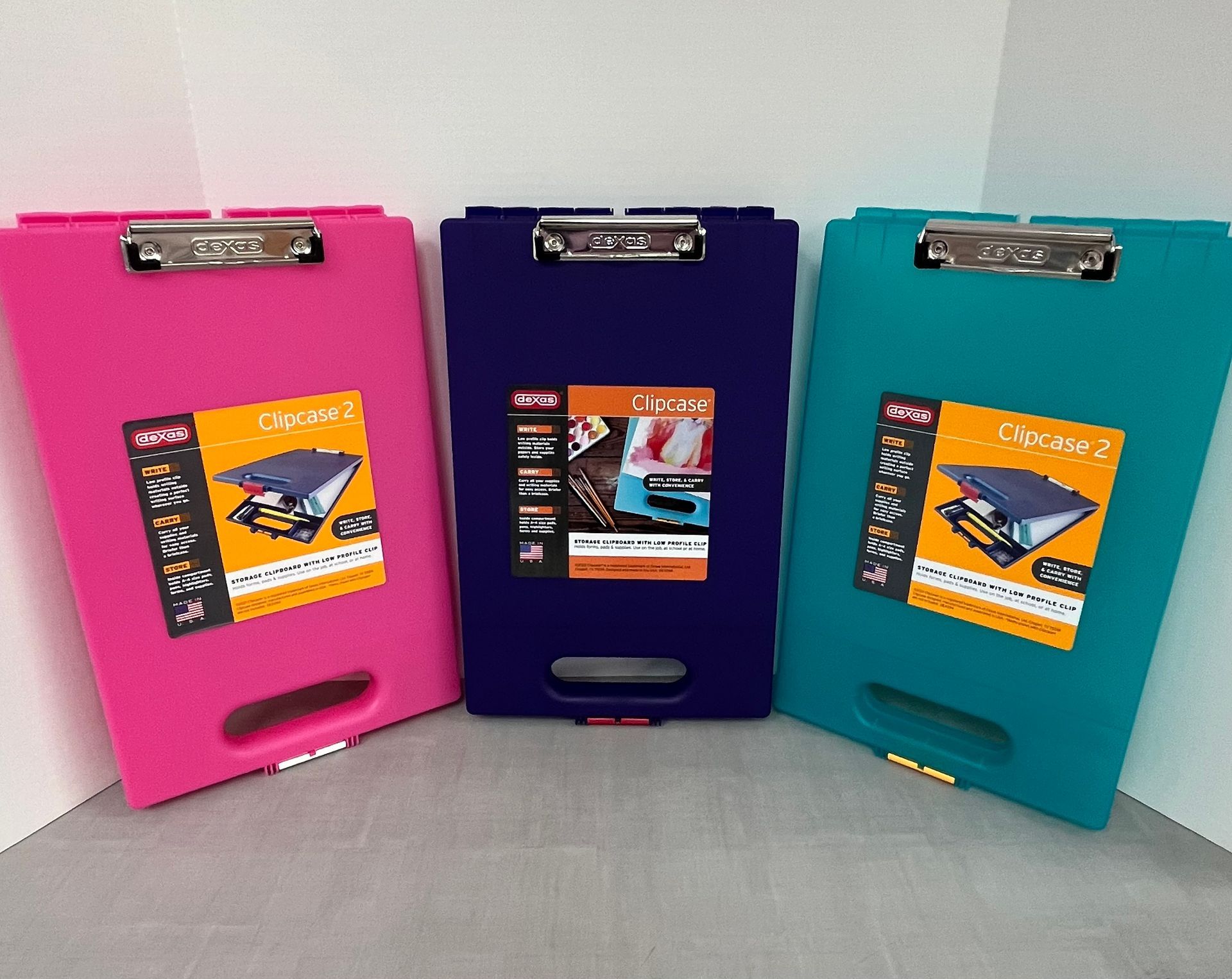 three clipboards are sitting next to each other on a table .