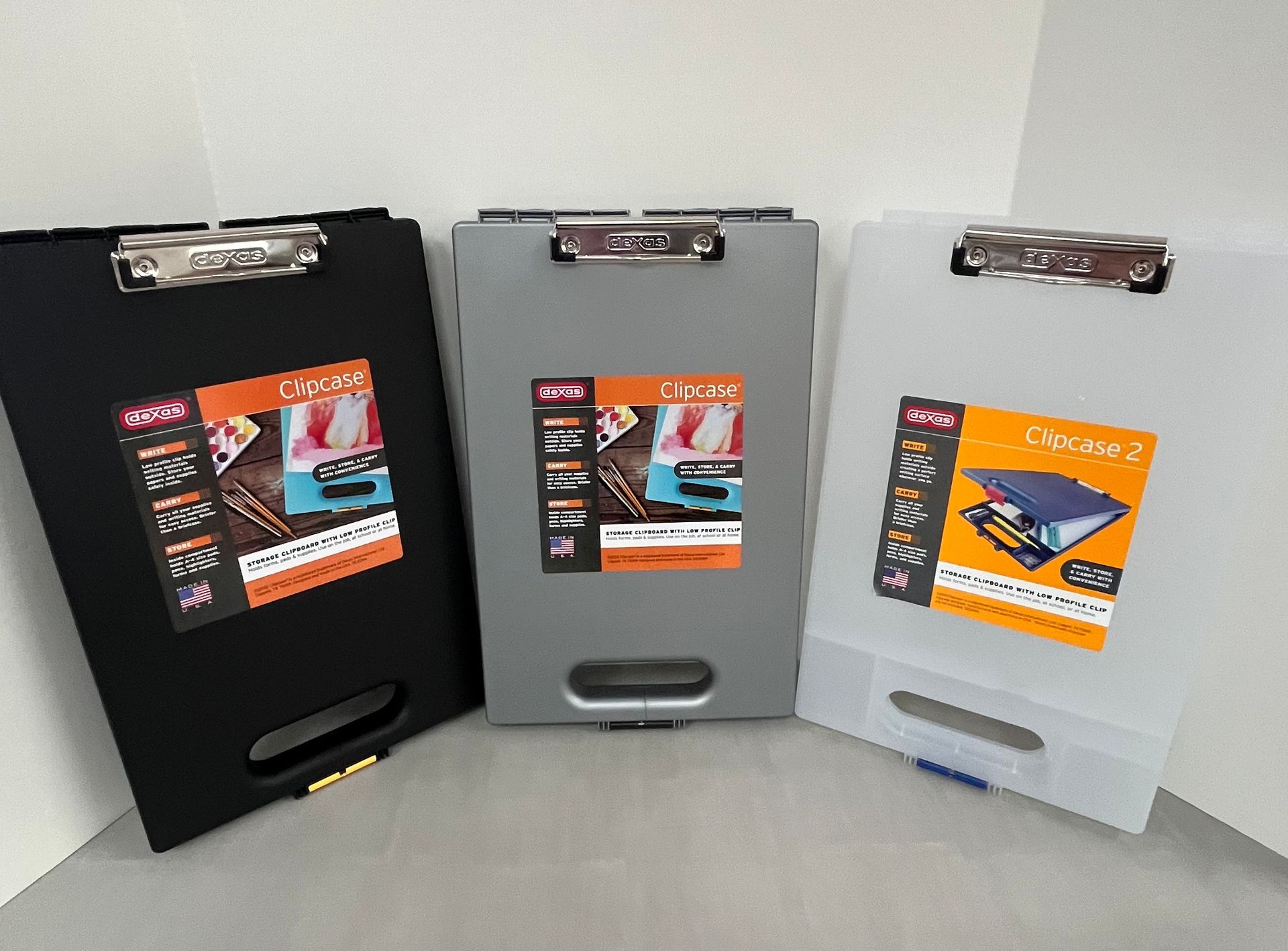 three clipboards are sitting next to each other on a table .