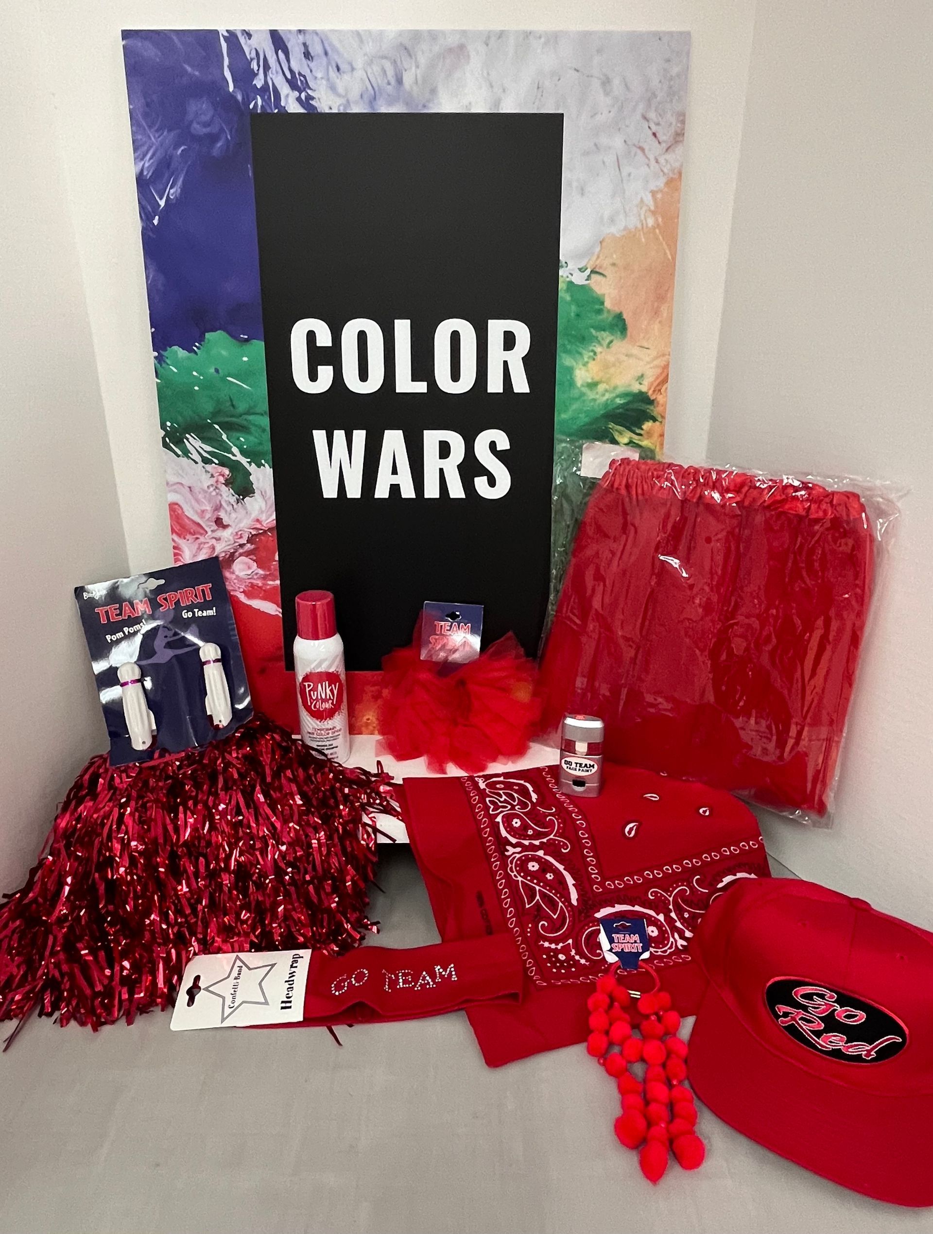 a box filled with red items and a sign that says color wars