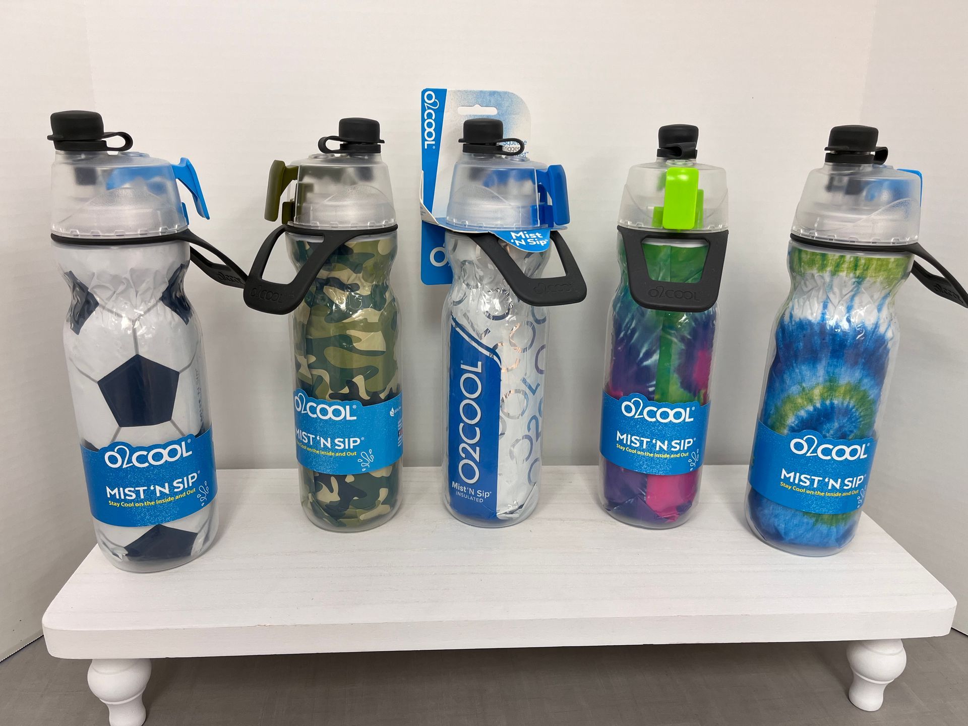 a group of water bottles sitting on top of a white table .