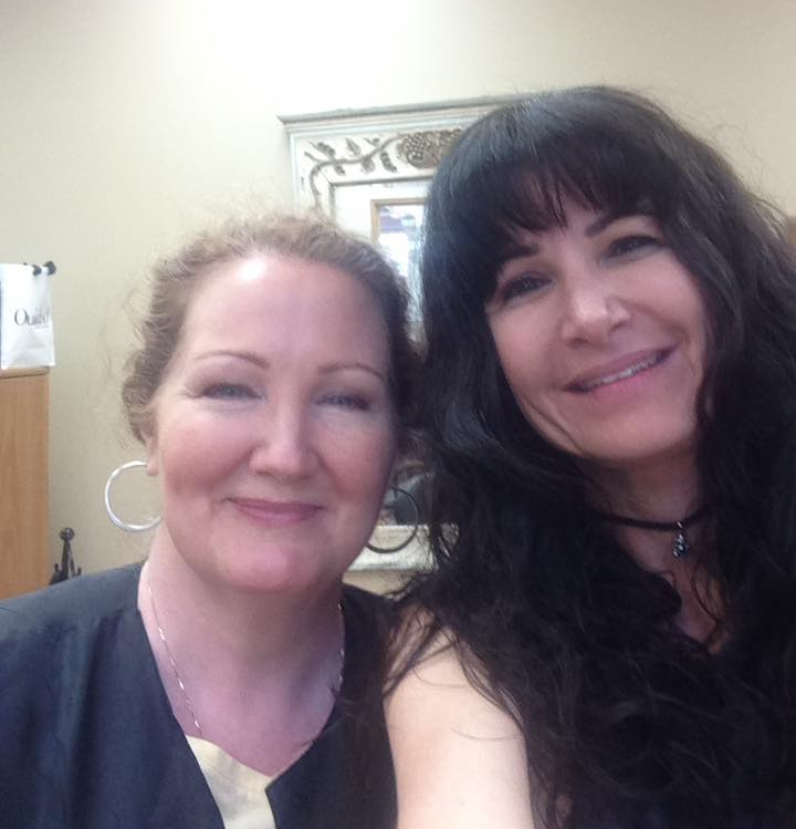 two women are posing for a picture and smiling for the camera