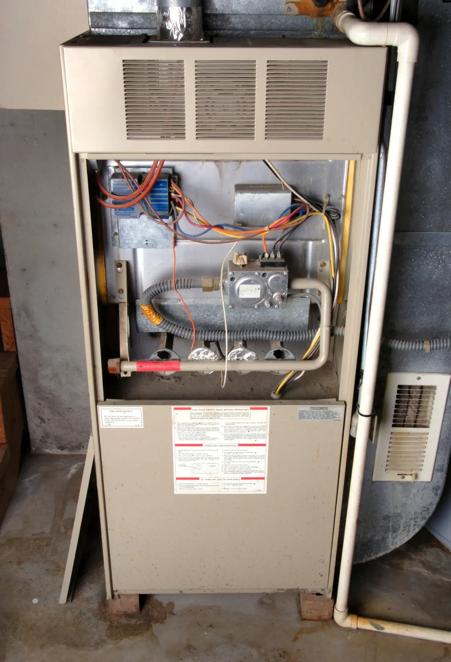The inside of a furnace is shown with the door open.