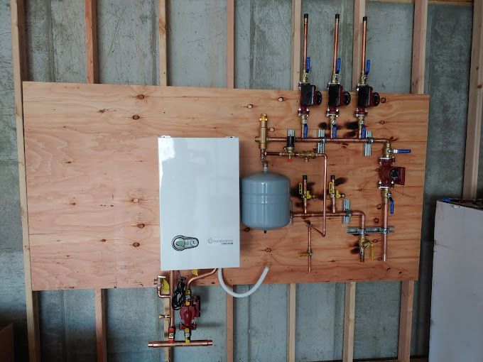 A plumbing system is hanging on a wooden wall.