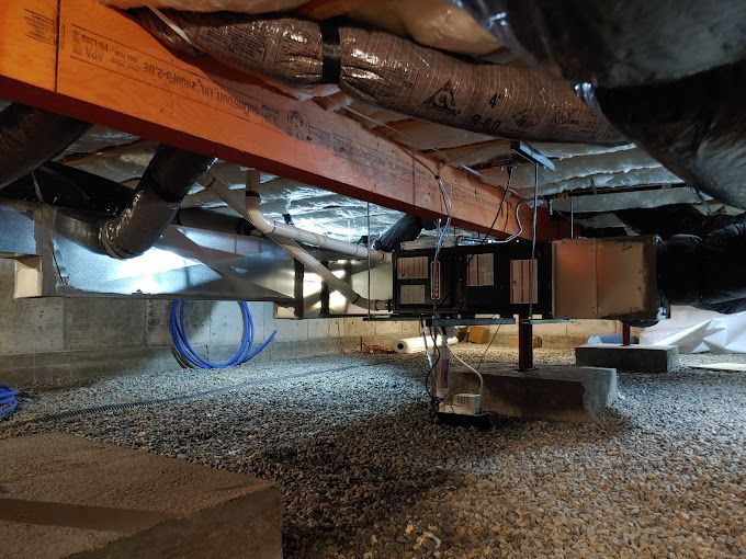 A basement with a lot of pipes coming out of it