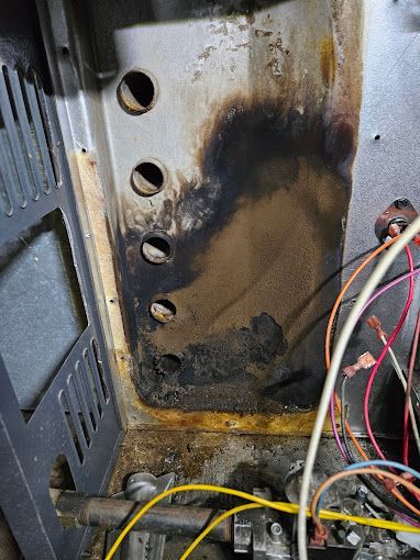 A close up of a microwave oven with a lot of wires coming out of it.