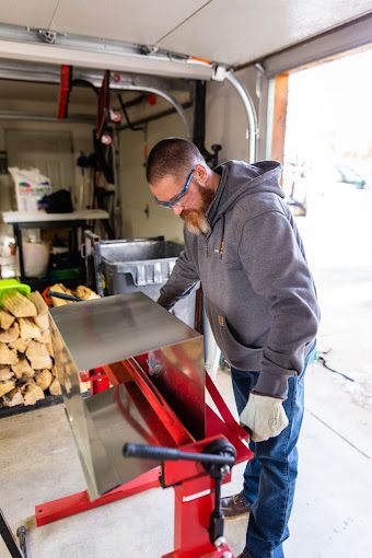 A man is working on a machine in a garage.