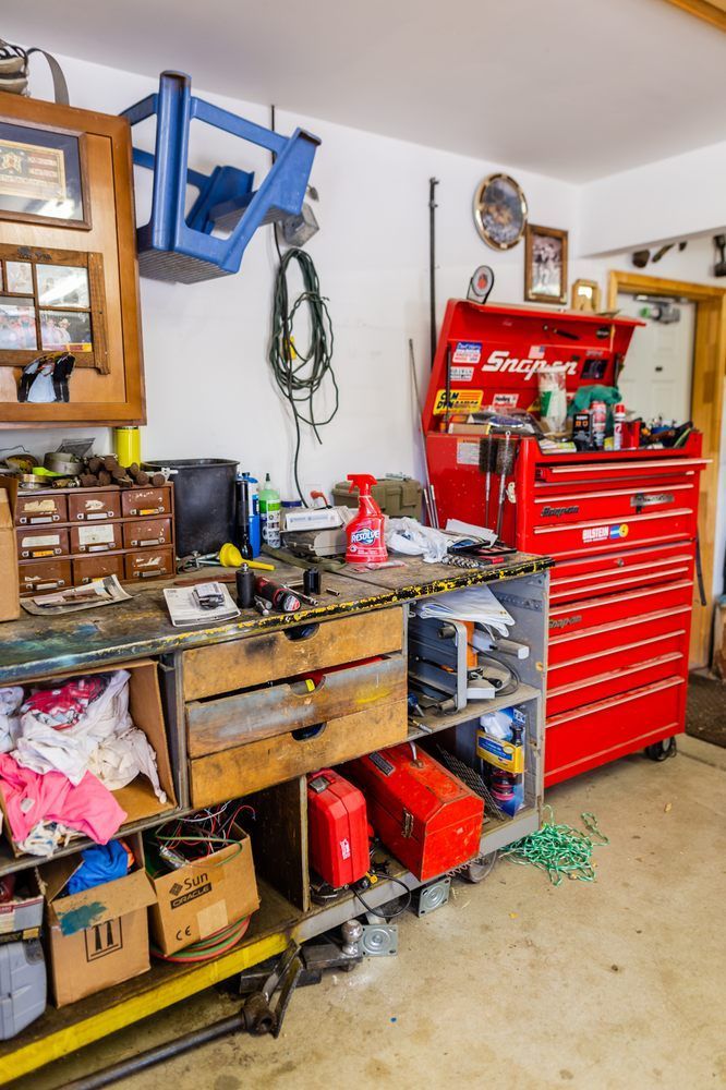 A garage filled with lots of tools and a red toolbox.