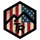 A logo with an american flag and a mountain in the middle.
