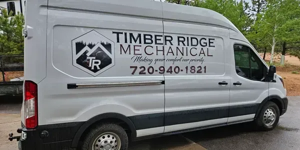 A white van is parked on the side of the road.