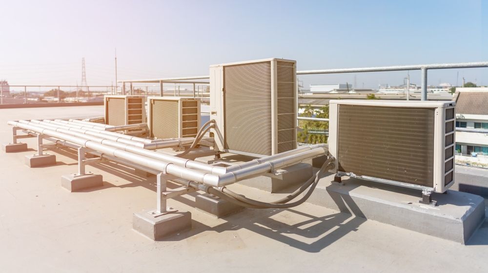 There Are Many Air Conditioners on the Roof of a Building — Airac Sales & Service in Berserker, QLD