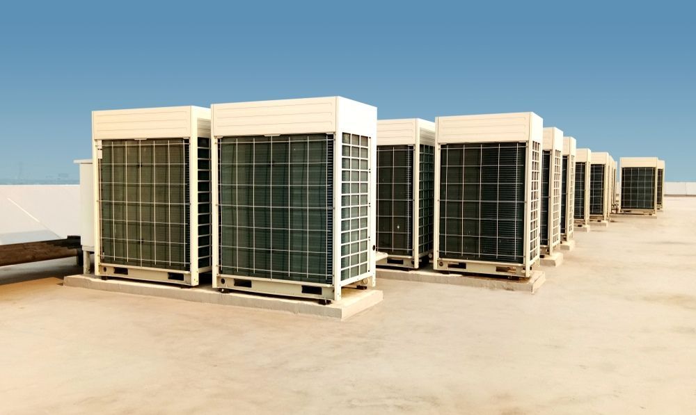A Row of Air Conditioners Sitting on Top of a Roof — Airac Sales & Service in Berserker, QLD