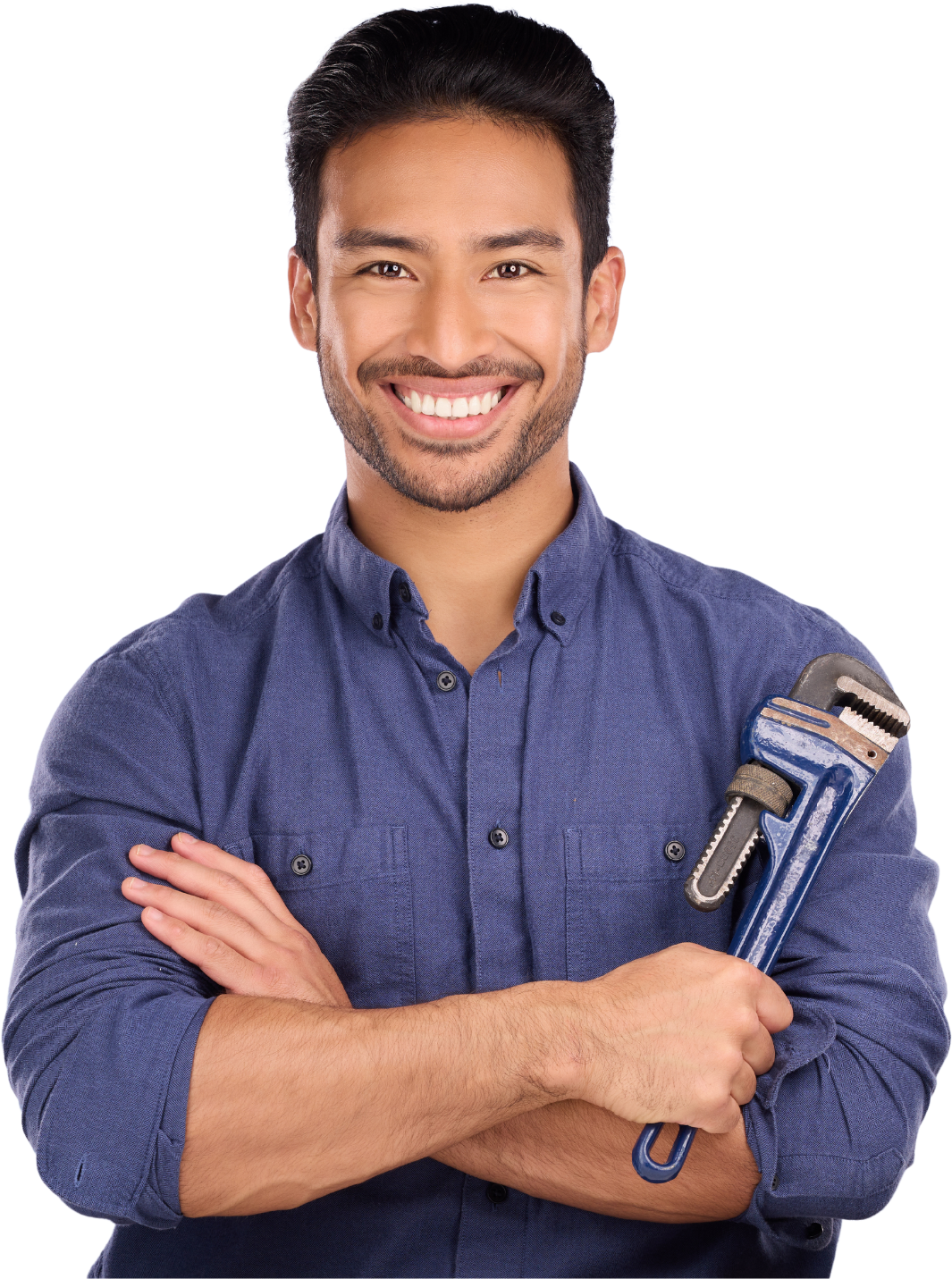 A man in a blue shirt is holding a wrench and smiling.