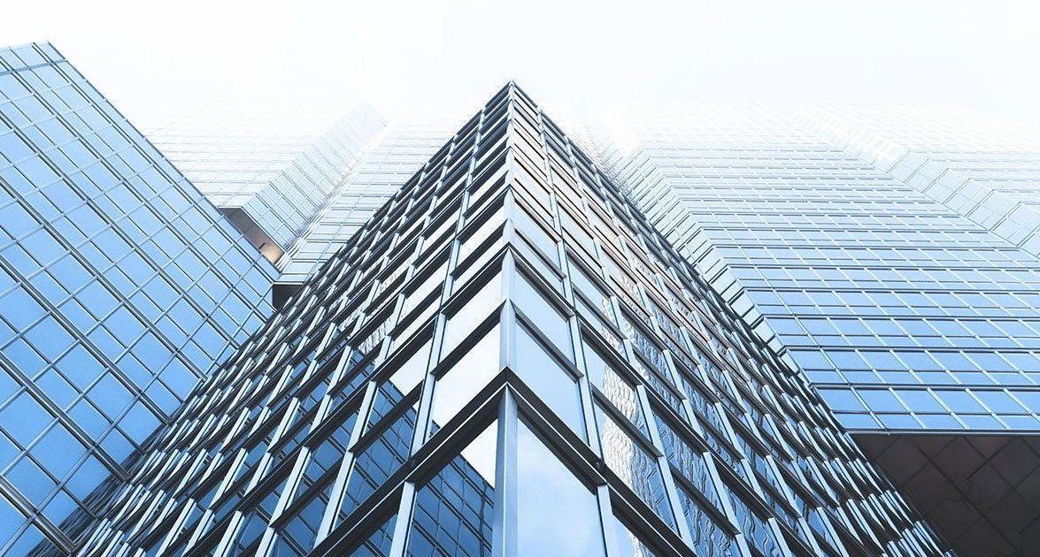 Looking up at a tall building with a lot of windows.