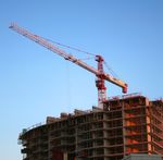 Large building under construction with crane