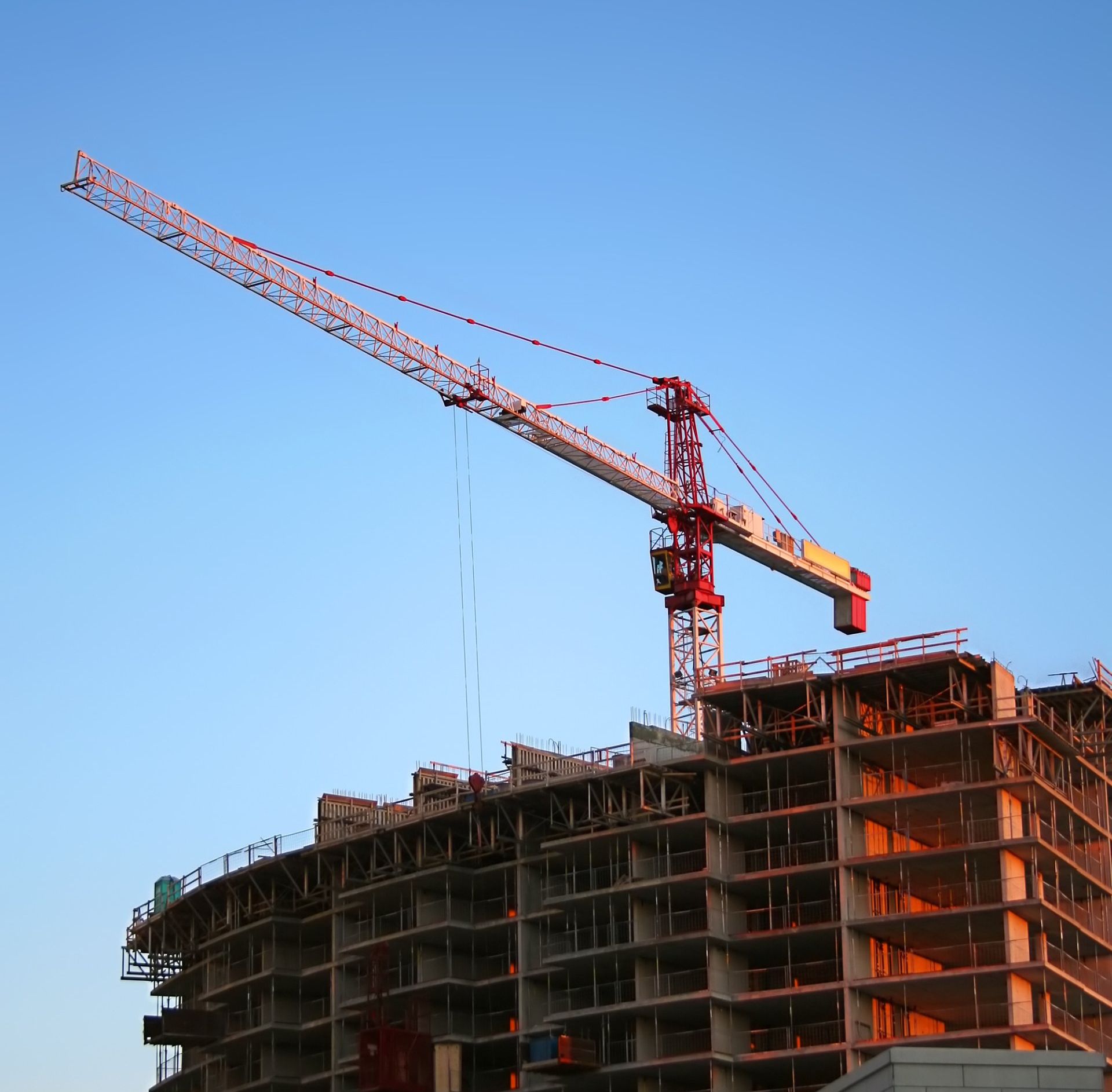 Large building under construction with crane