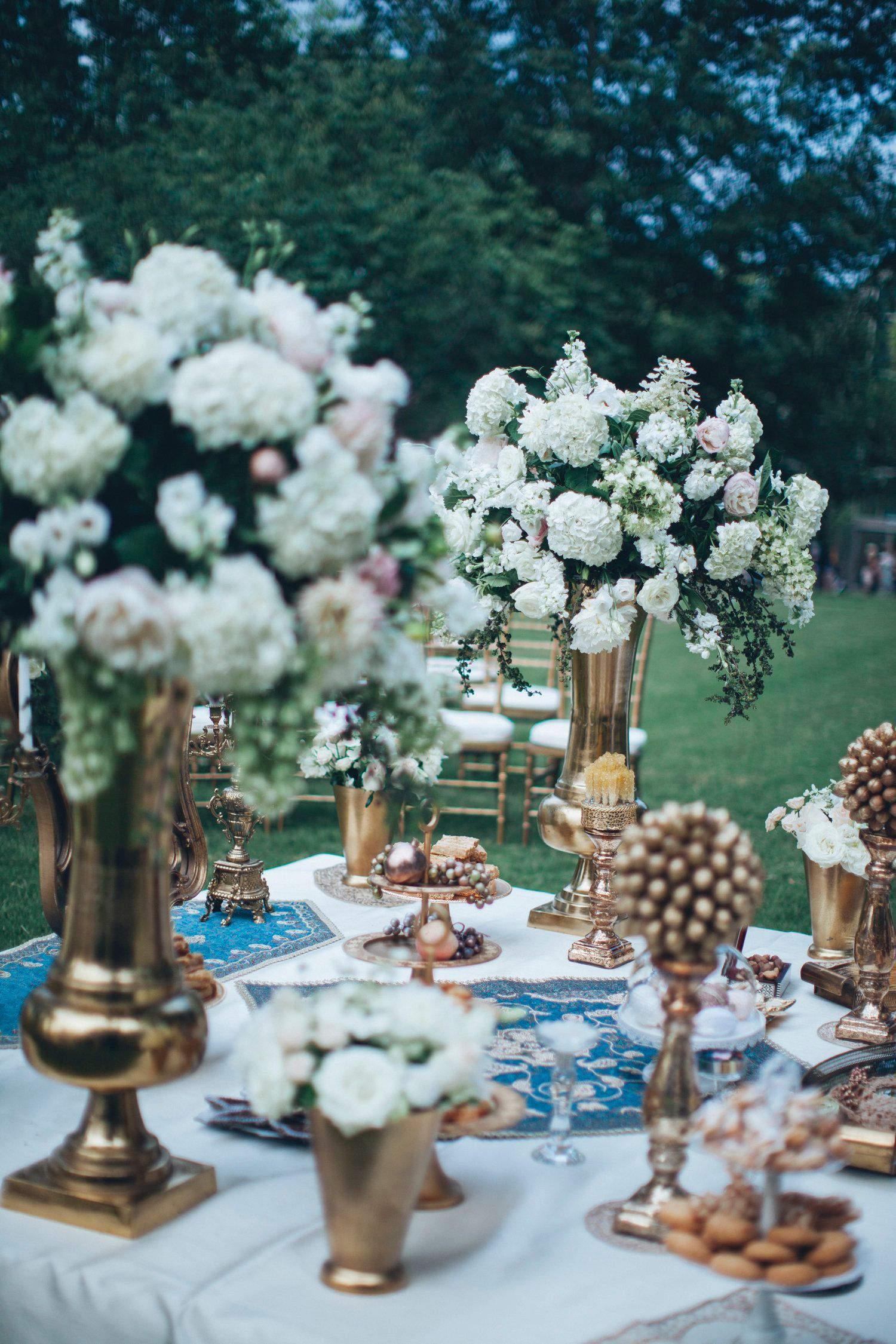 Bahar & Charlie's Wedding table with flowers and candles on it in a park by Wedding Planner Nashville