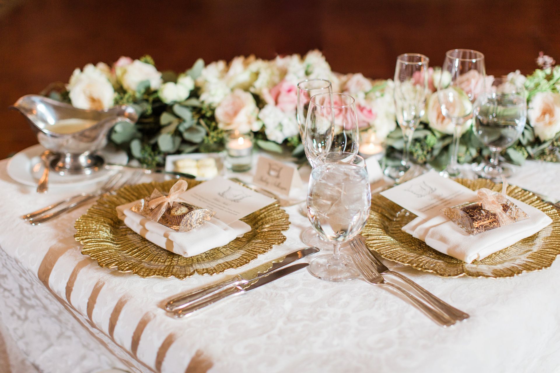 Bailey and Sam’s Wedding table set for their wedding reception with plates, utensils, and flowers by Wedding Planner Nashville