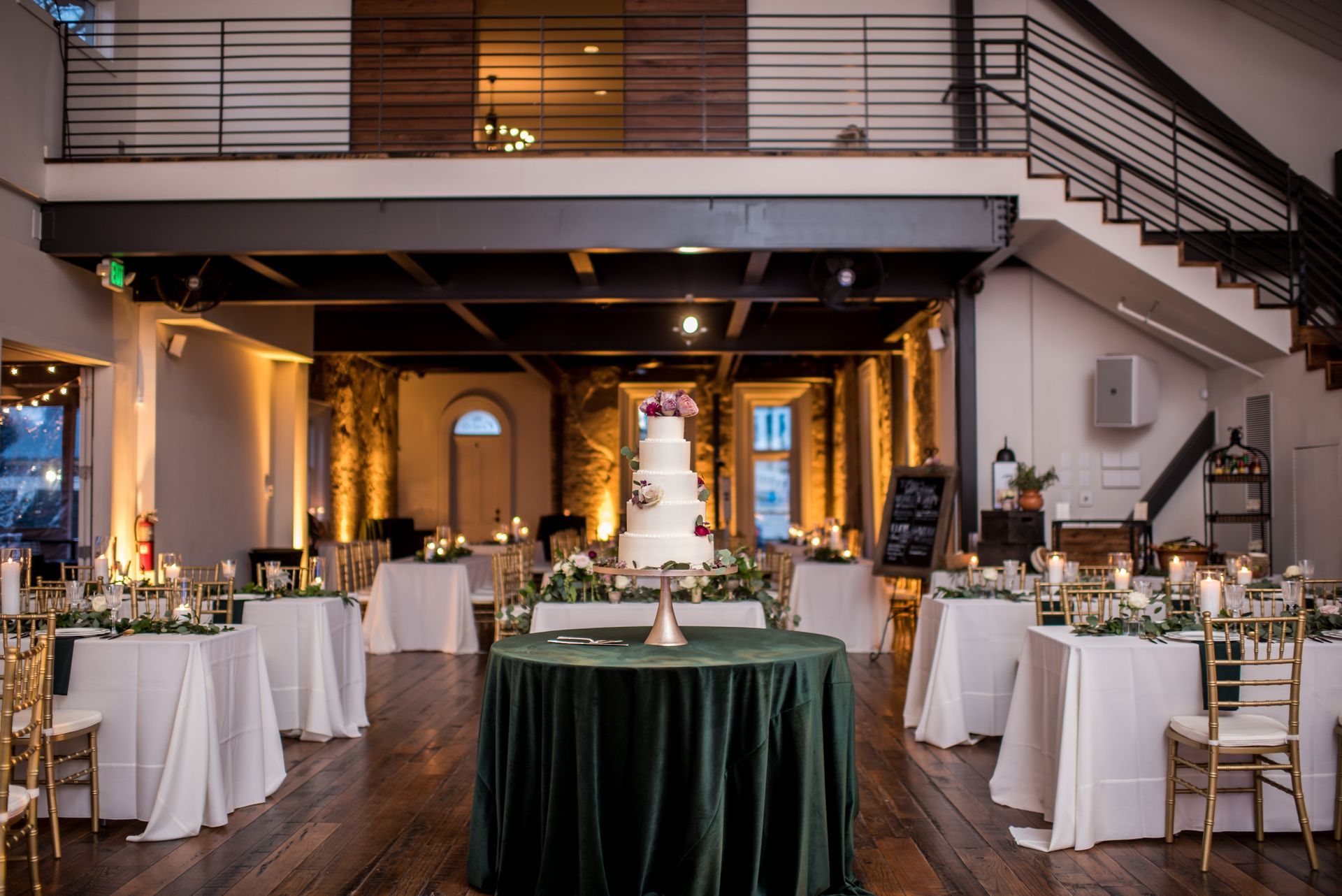 Cheyna and Jordan’s Wedding room with tables and chairs and a wedding cake on a table by Wedding Planner Nashville