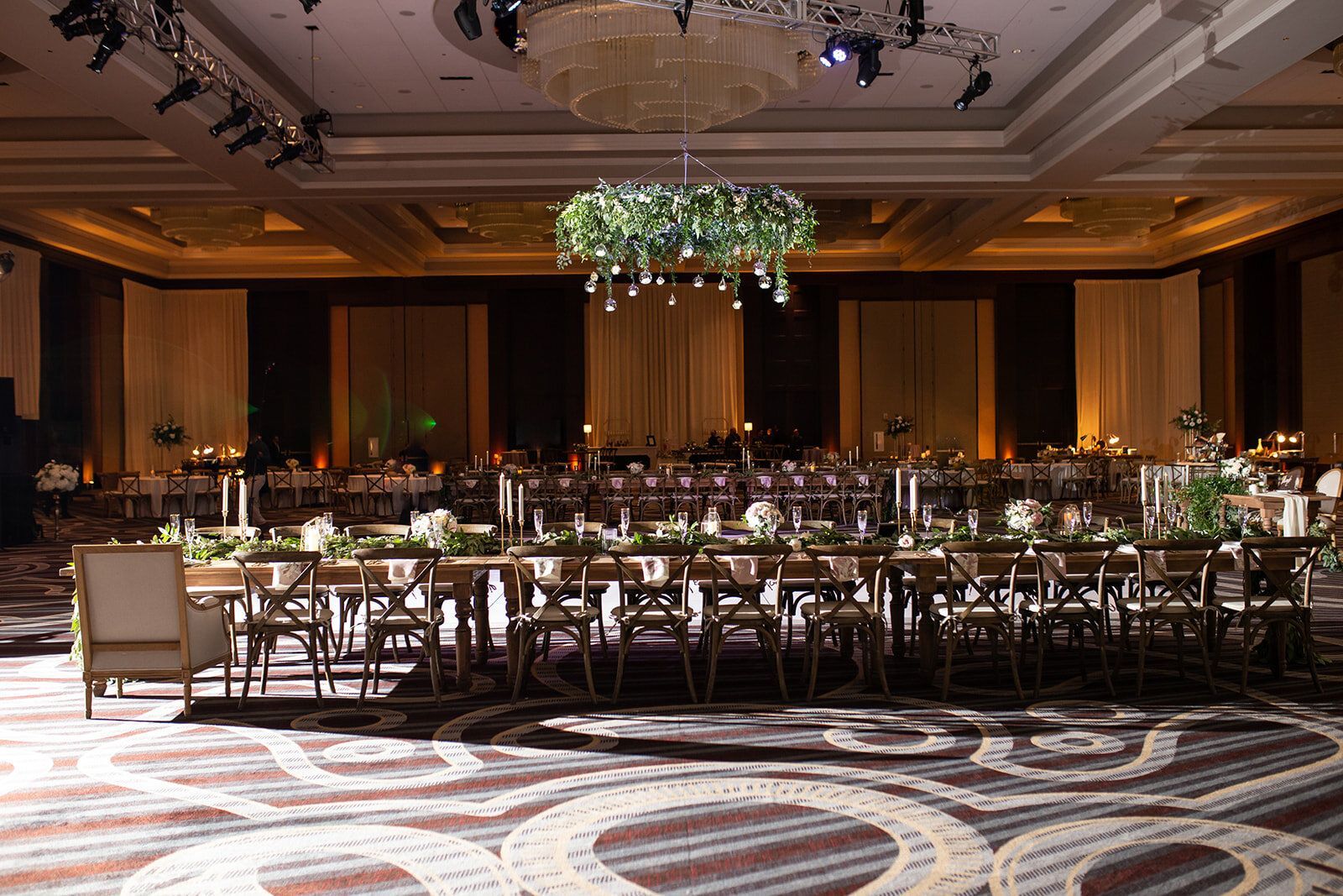 Constance and Zarif’s Wedding, large ballroom with tables and chairs and a chandelier hanging from the ceiling by Wedding Planner Nashville
