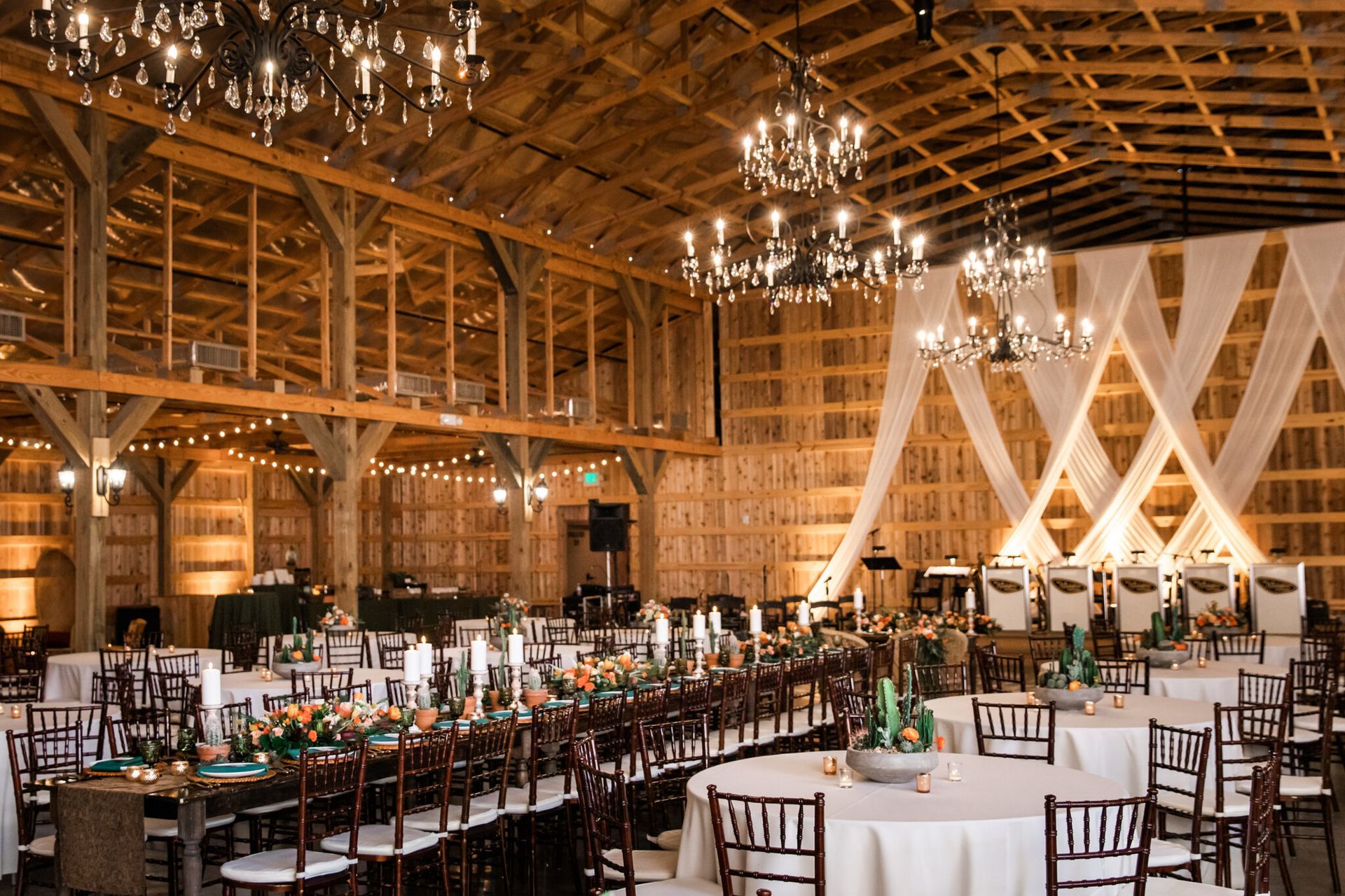 Emily and Jared’s Wedding, large barn filled with tables and chairs for a wedding reception by Wedding Planner Nashville