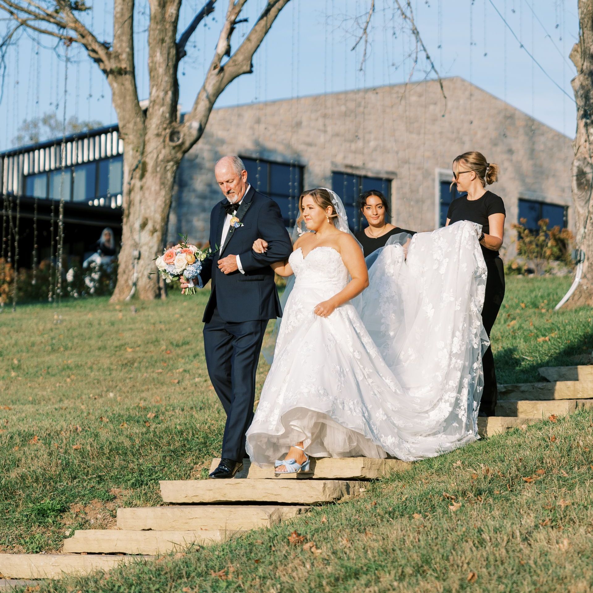 A Woman Is Standing Next to a Table Set for a Wedding Reception by Wedding Planner Nashville