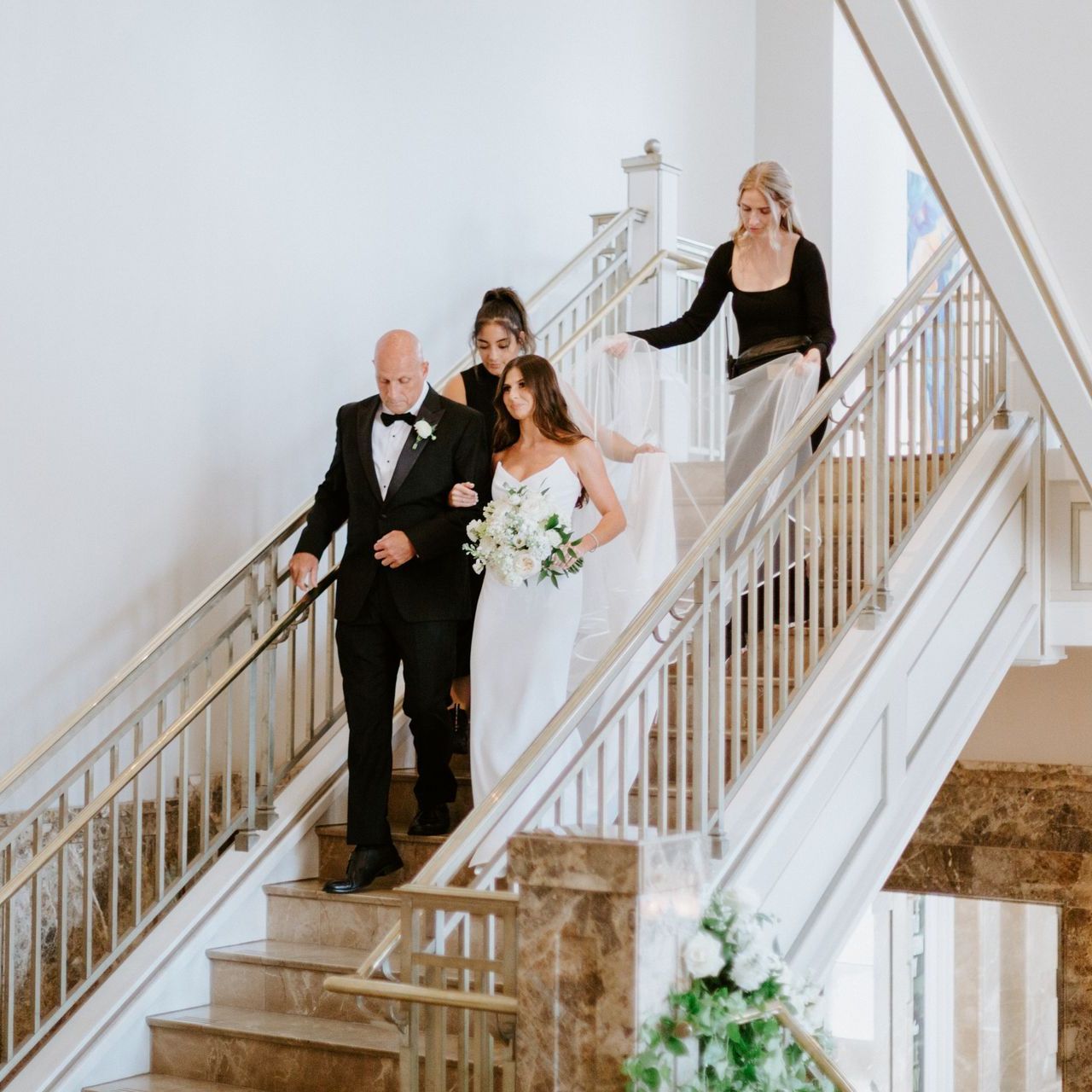 A Wedding Reception in a with a Long Table and Chairs by Wedding Planner Nashville
