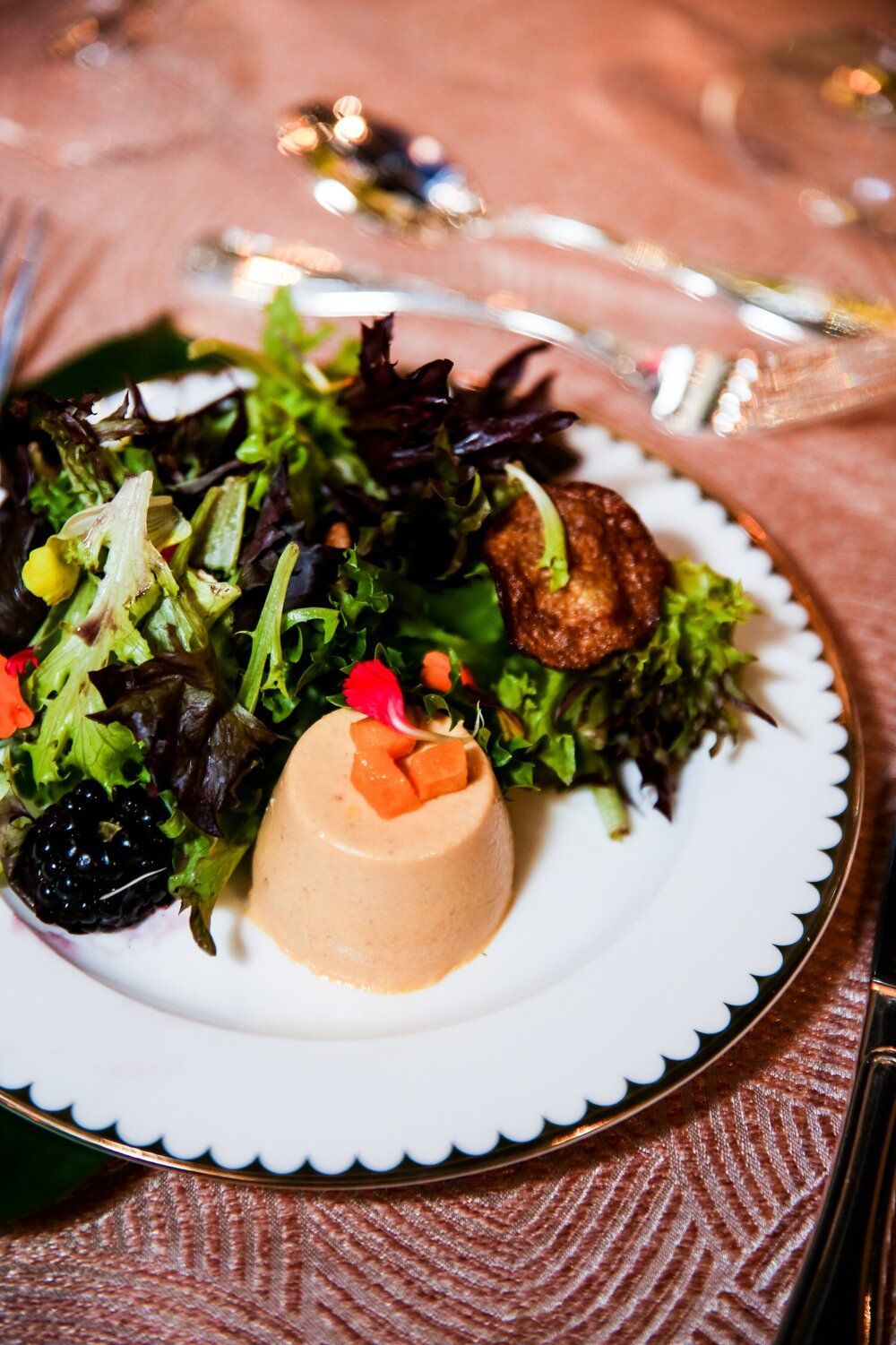 Micro Weddings white plate topped with a salad and a dessert on a table by Wedding Planner Nashville